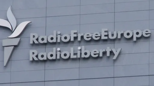 Photo of the name and torch logo on the headquarters in Prague