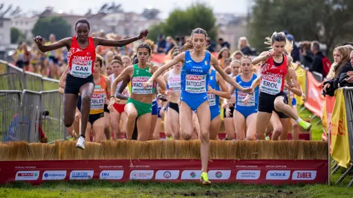 This is a photo of the finish line of a women's sprint, with women athletes just crossing the line